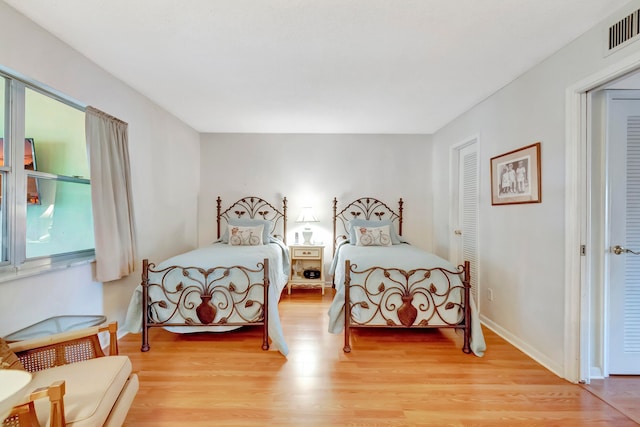 bedroom featuring light hardwood / wood-style floors and a closet