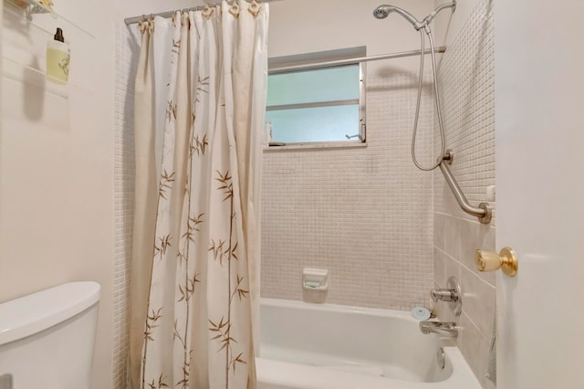 bathroom with toilet and shower / bathtub combination with curtain