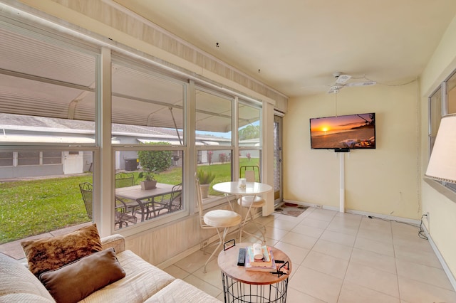 sunroom / solarium featuring ceiling fan