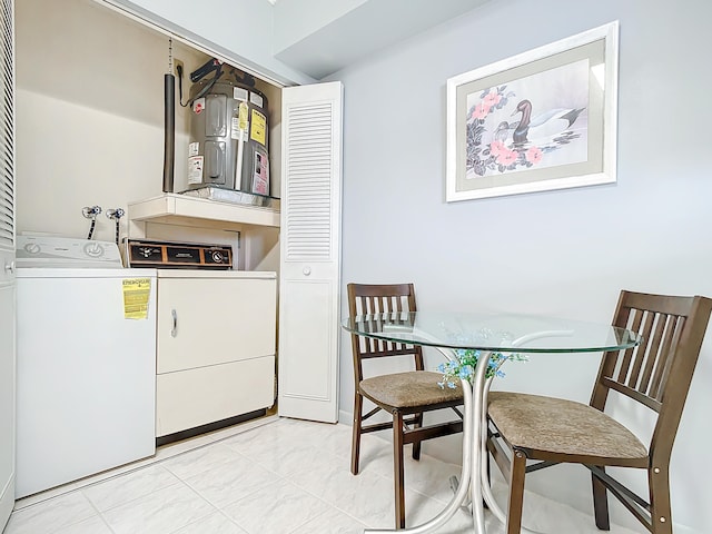 washroom featuring hookup for a washing machine, independent washer and dryer, and light tile flooring