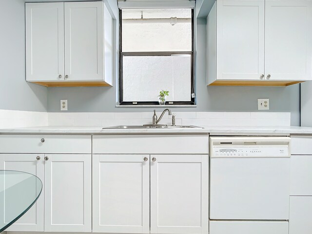 kitchen featuring sink, white cabinetry, and dishwasher