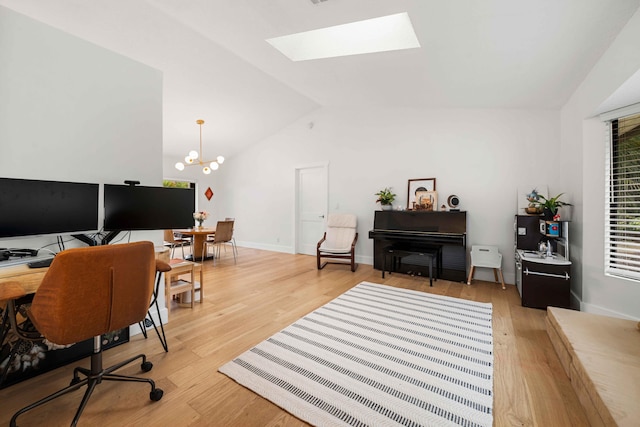 office space with vaulted ceiling with skylight, light hardwood / wood-style floors, and an inviting chandelier