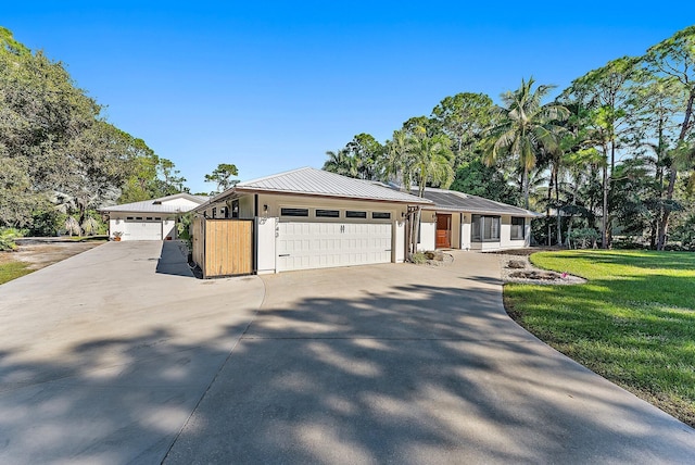 ranch-style home featuring a front lawn and a garage