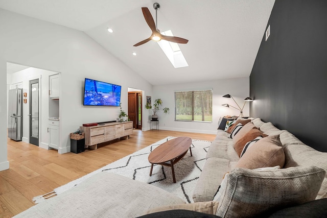 living room with light wood-type flooring, high vaulted ceiling, and ceiling fan