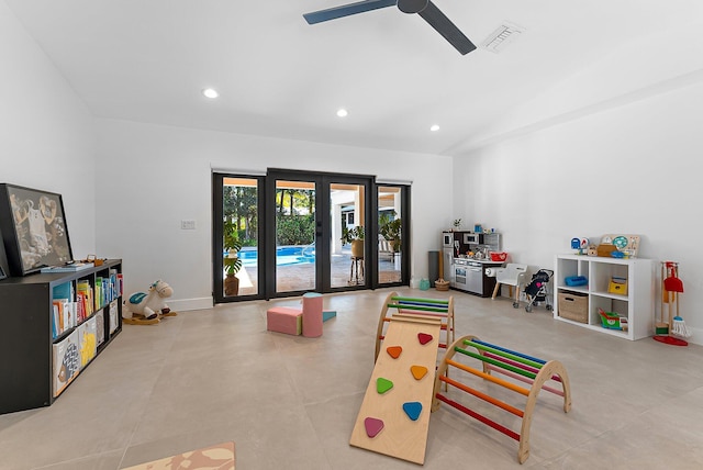 playroom with ceiling fan, french doors, and vaulted ceiling