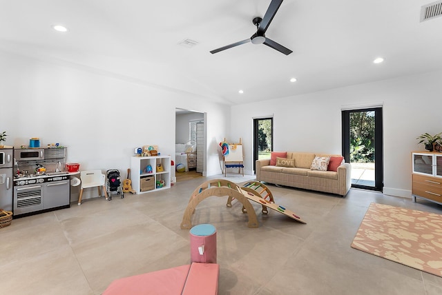 living room with ceiling fan and vaulted ceiling