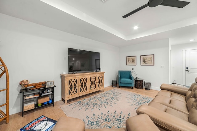 living room featuring light hardwood / wood-style flooring and ceiling fan