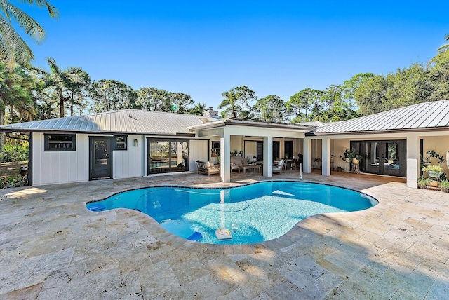 view of swimming pool with an outdoor living space and a patio