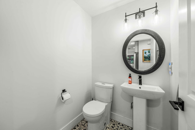 bathroom featuring tile patterned flooring and toilet