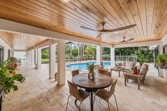 exterior space featuring an outdoor living space, ceiling fan, and a fenced in pool