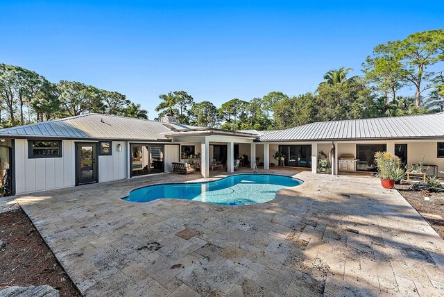 view of swimming pool with a grill and a patio area