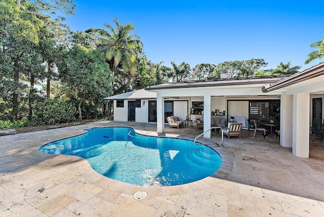 view of swimming pool with outdoor lounge area and a patio area