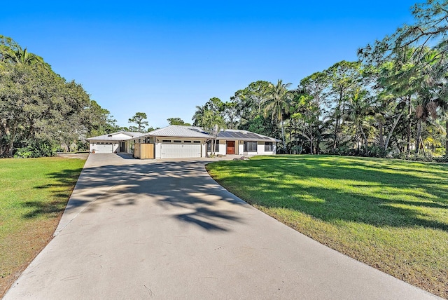 ranch-style house featuring a front lawn, a garage, and solar panels