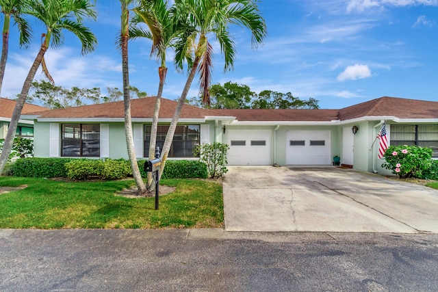 ranch-style home with a front lawn and a garage