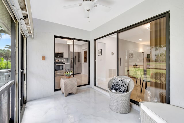 sunroom featuring ceiling fan