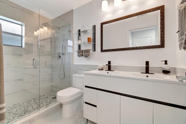 bathroom featuring toilet, vanity with extensive cabinet space, tile floors, and a shower with door