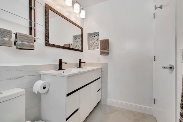 bathroom featuring toilet, tile flooring, vanity, and tile walls