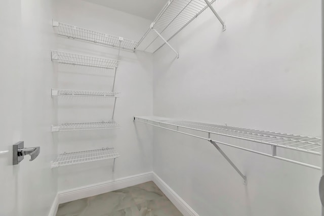 spacious closet with tile flooring