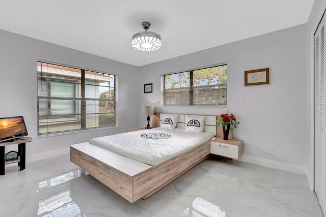 tiled bedroom featuring a closet