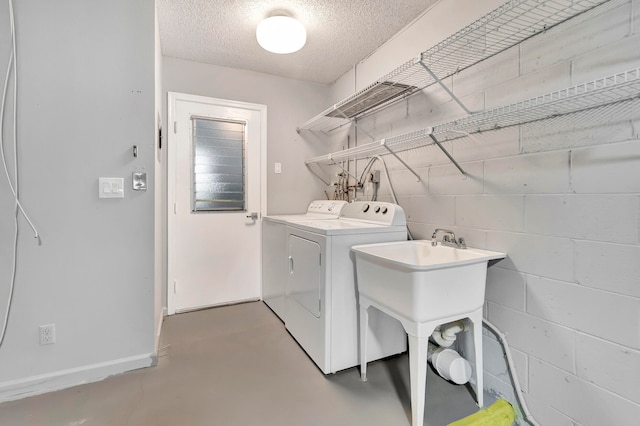 laundry room featuring washer hookup, washing machine and dryer, and a textured ceiling