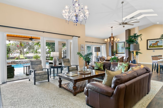 living room with ceiling fan with notable chandelier, light wood-type flooring, and lofted ceiling