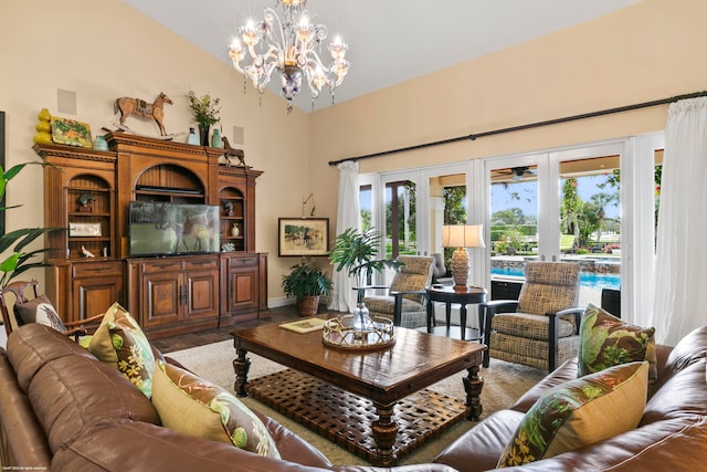 living room featuring an inviting chandelier, french doors, and dark wood-type flooring