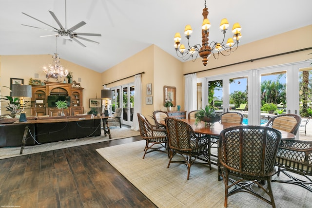 dining space with lofted ceiling, hardwood / wood-style floors, french doors, and ceiling fan with notable chandelier