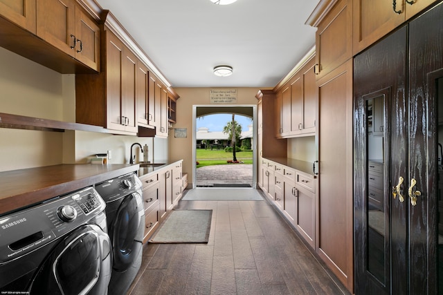 washroom featuring cabinets, washing machine and clothes dryer, and sink