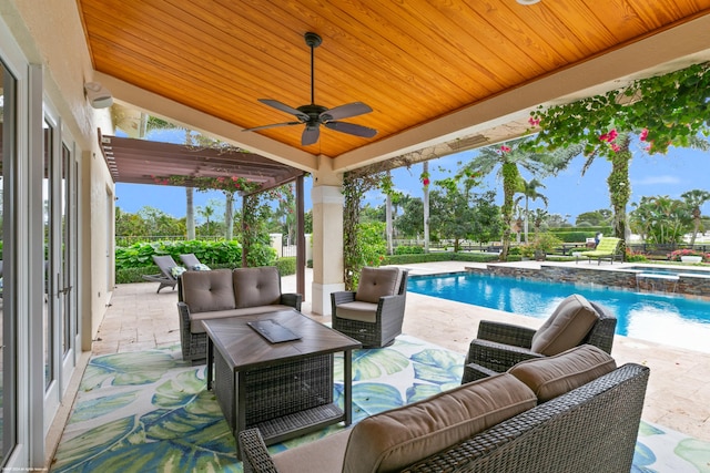 exterior space featuring an outdoor living space, ceiling fan, and a patio area