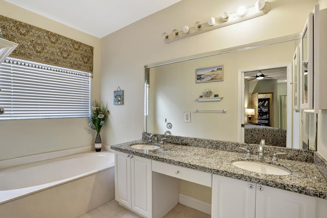 bathroom featuring ceiling fan, a tub, tile patterned flooring, and vanity