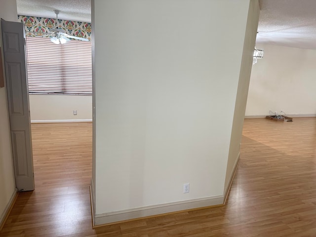 hallway featuring hardwood / wood-style flooring and a textured ceiling