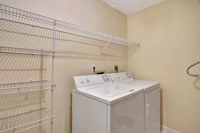 clothes washing area featuring washing machine and clothes dryer