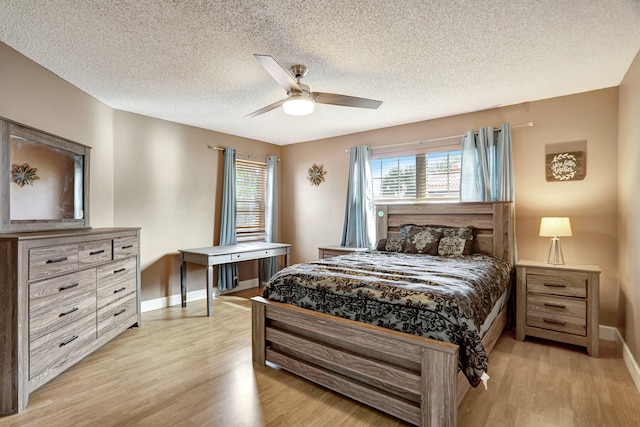 bedroom featuring a textured ceiling, ceiling fan, and light hardwood / wood-style flooring