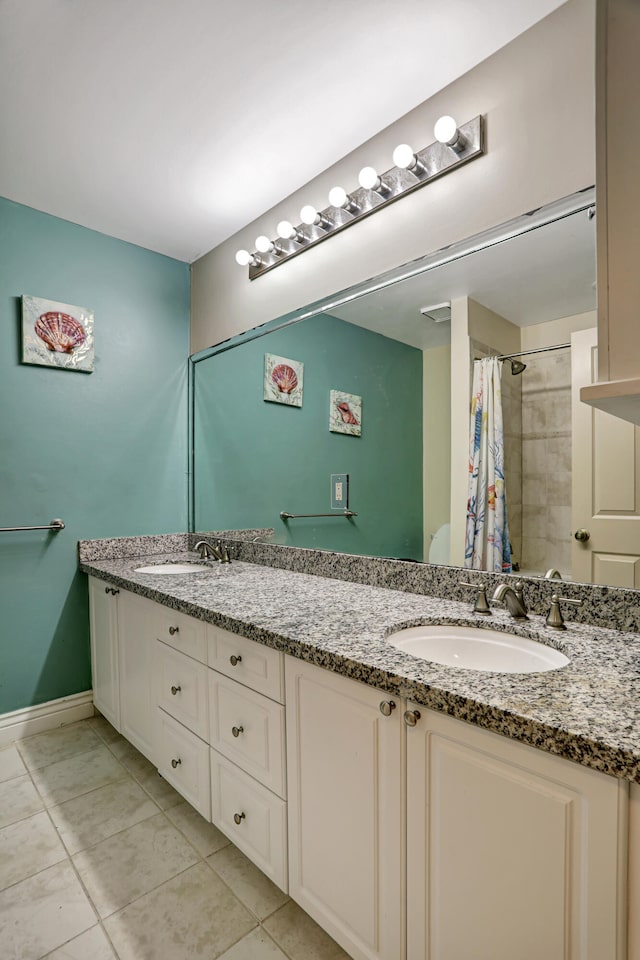 bathroom featuring a shower with shower curtain, vanity, and tile patterned floors