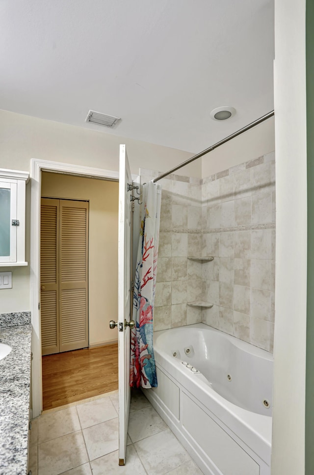 bathroom with vanity, shower / bath combination with curtain, and hardwood / wood-style floors