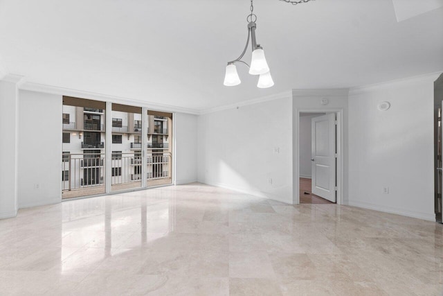 empty room with ornamental molding and an inviting chandelier