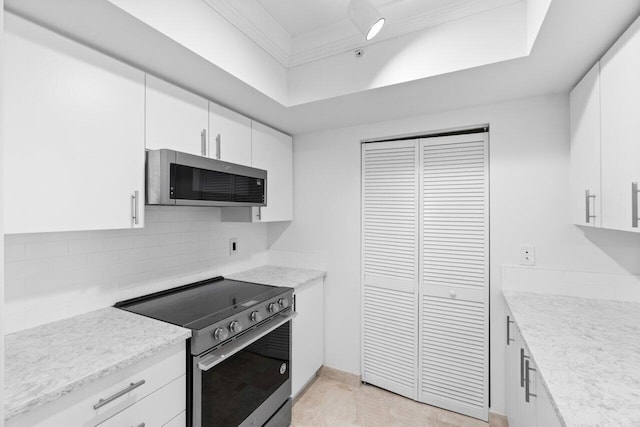 kitchen featuring appliances with stainless steel finishes, tasteful backsplash, and white cabinetry