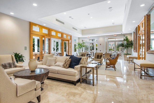 living room with french doors and a raised ceiling