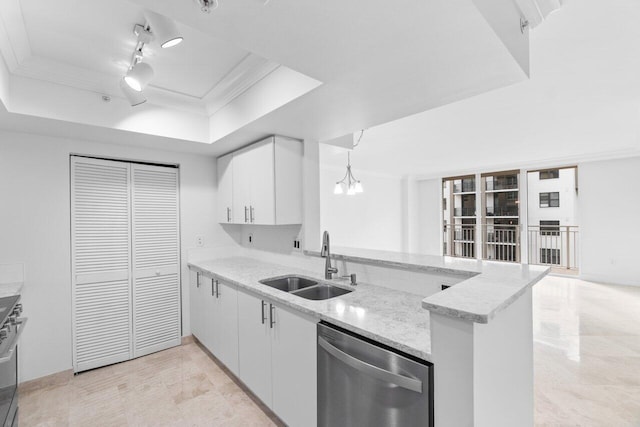 kitchen with appliances with stainless steel finishes, a tray ceiling, sink, white cabinets, and hanging light fixtures