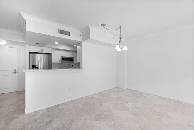 kitchen with white cabinets, hanging light fixtures, ornamental molding, kitchen peninsula, and stainless steel appliances