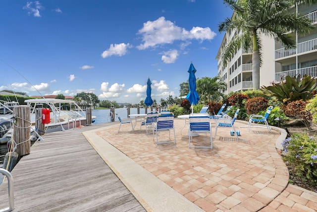 exterior space featuring a balcony and a water view