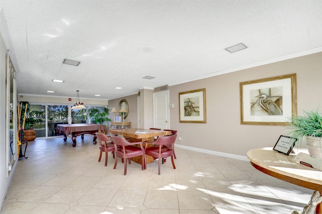 tiled dining room with pool table, ornamental molding, and a textured ceiling