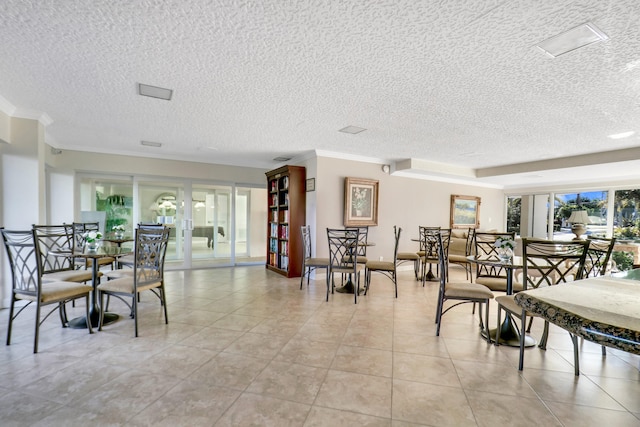 dining space featuring light tile floors, a textured ceiling, and crown molding