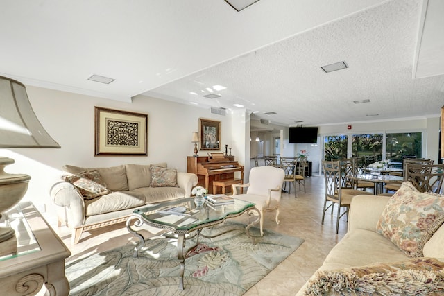 tiled living room featuring ornamental molding, a textured ceiling, and ornate columns