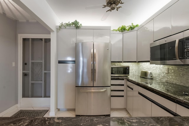 kitchen with ceiling fan, light tile floors, stainless steel appliances, tasteful backsplash, and white cabinetry