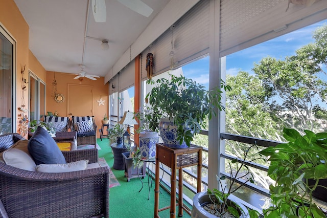 sunroom featuring ceiling fan