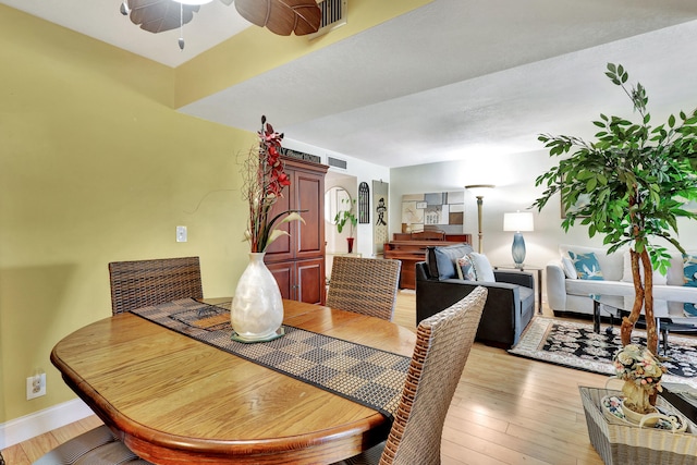 dining space featuring ceiling fan and light wood-type flooring