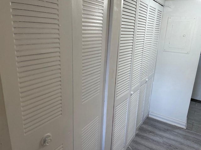 interior details with wood-type flooring and electric panel