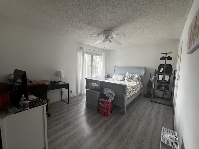 bedroom with hardwood / wood-style floors, a textured ceiling, and ceiling fan