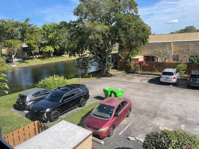 view of parking / parking lot with a water view